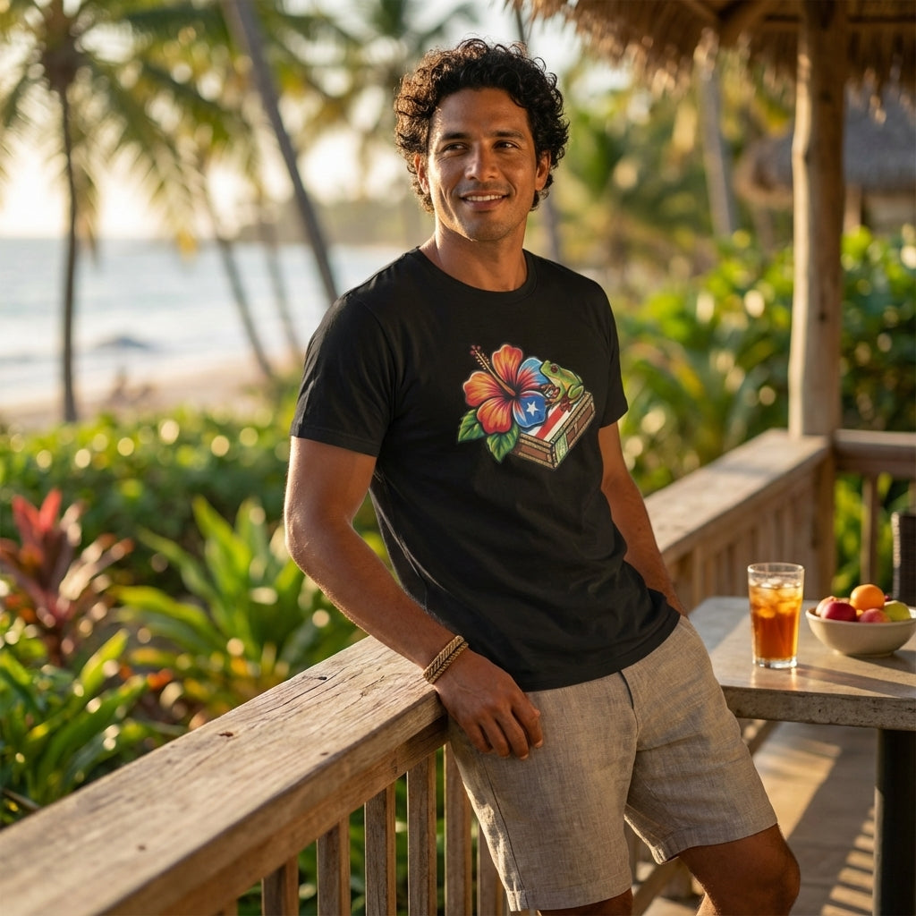 Man wearing a black t-shirt with a colorful graphic design, standing on a wooden deck with a tropical background.