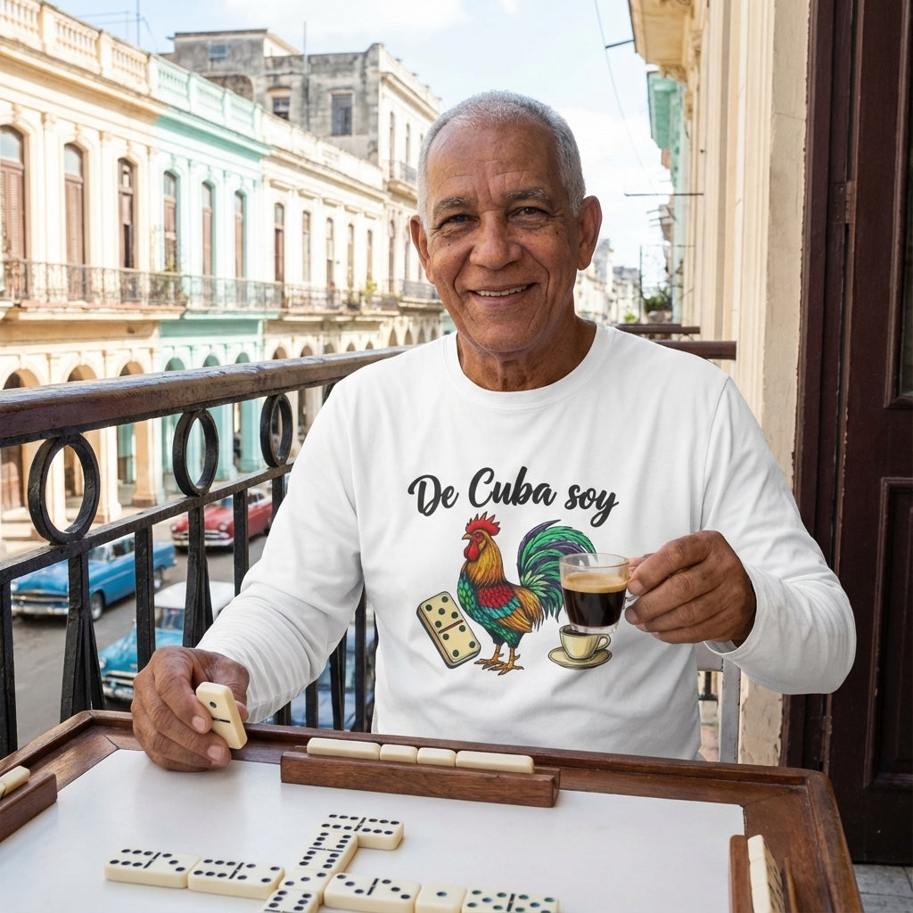 Man playing dominoes on a balcony with a 'De Cuba soy' shirt featuring a rooster, coffee cup, and dice.
