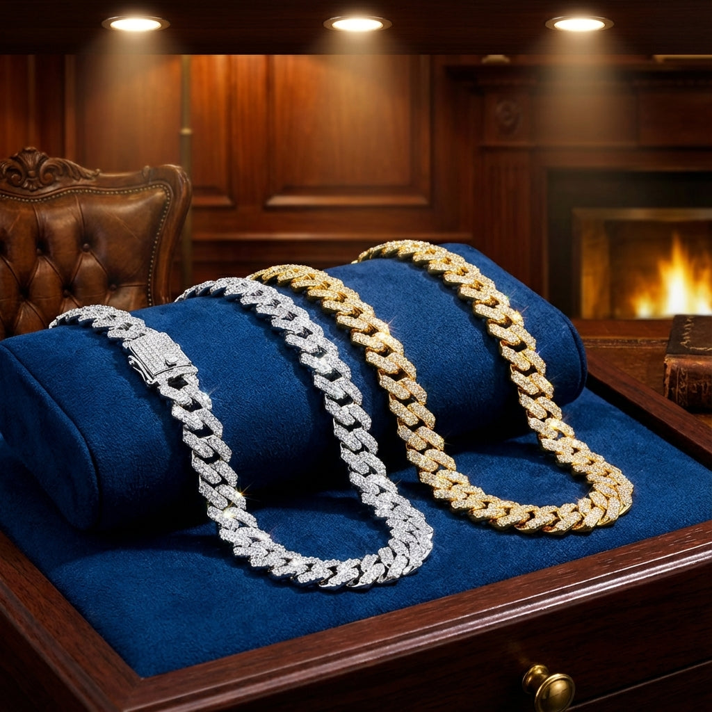 Two gold and silver chain necklaces on blue fabric with a warm background.