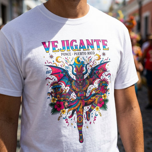 A white short-sleeve t-shirt with a vibrant, colorful graphic of a dancing devil and the text 'VEJIGANTE Ponce - Puerto Rico', worn by a person in an outdoor setting.