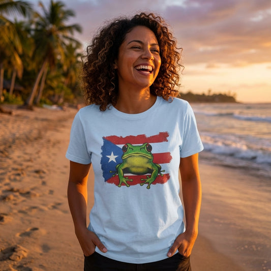 Woman wearing a t-shirt with a frog graphic on a beach at sunset