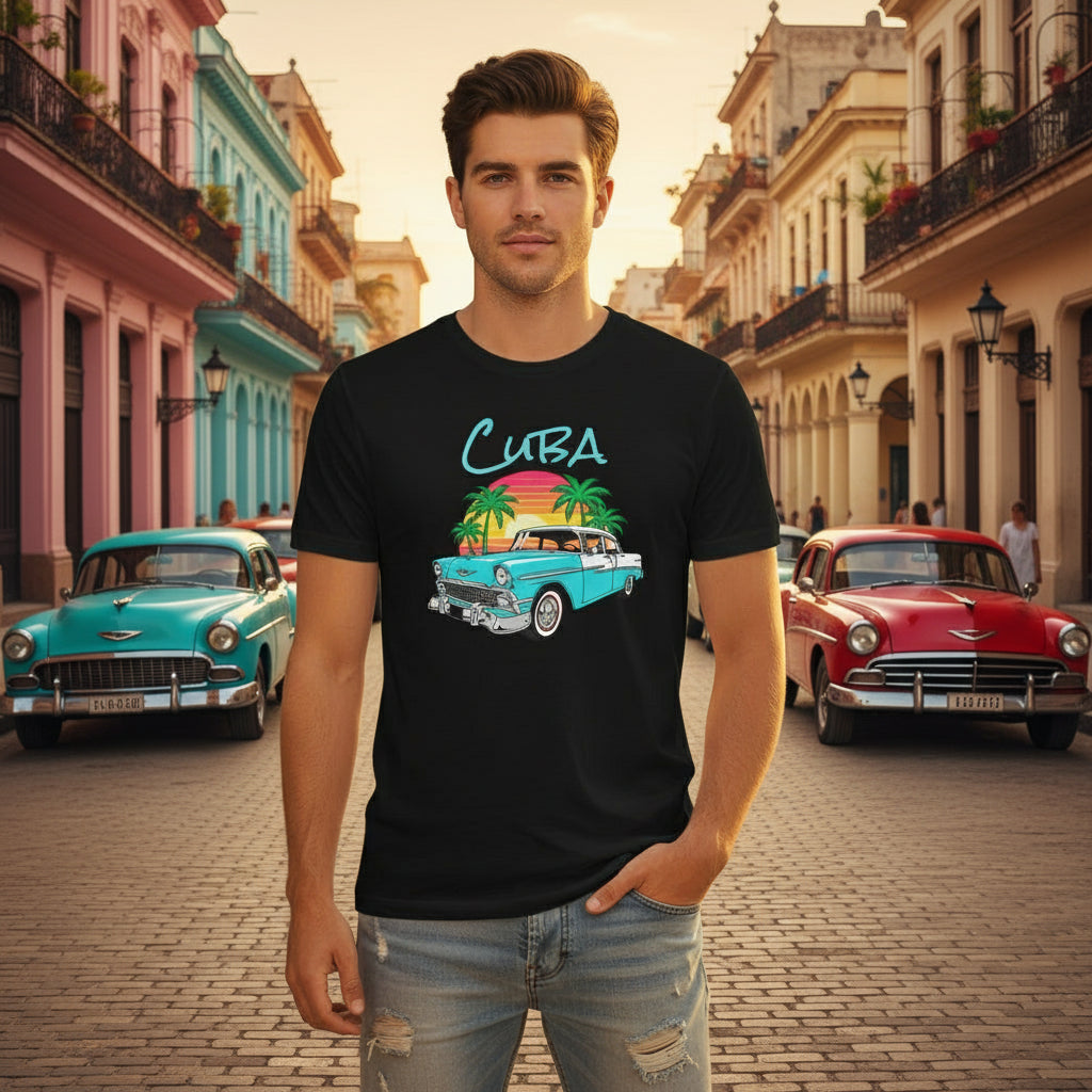 Man wearing a black t-shirt with a Cuba-themed design on a street with vintage cars.