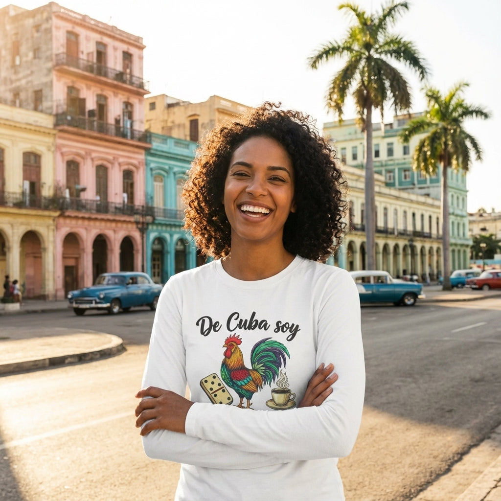 Woman wearing a white long-sleeve shirt with a rooster graphic and 'De Cuba soy' text, standing in a street with colorful buildings and palm trees.