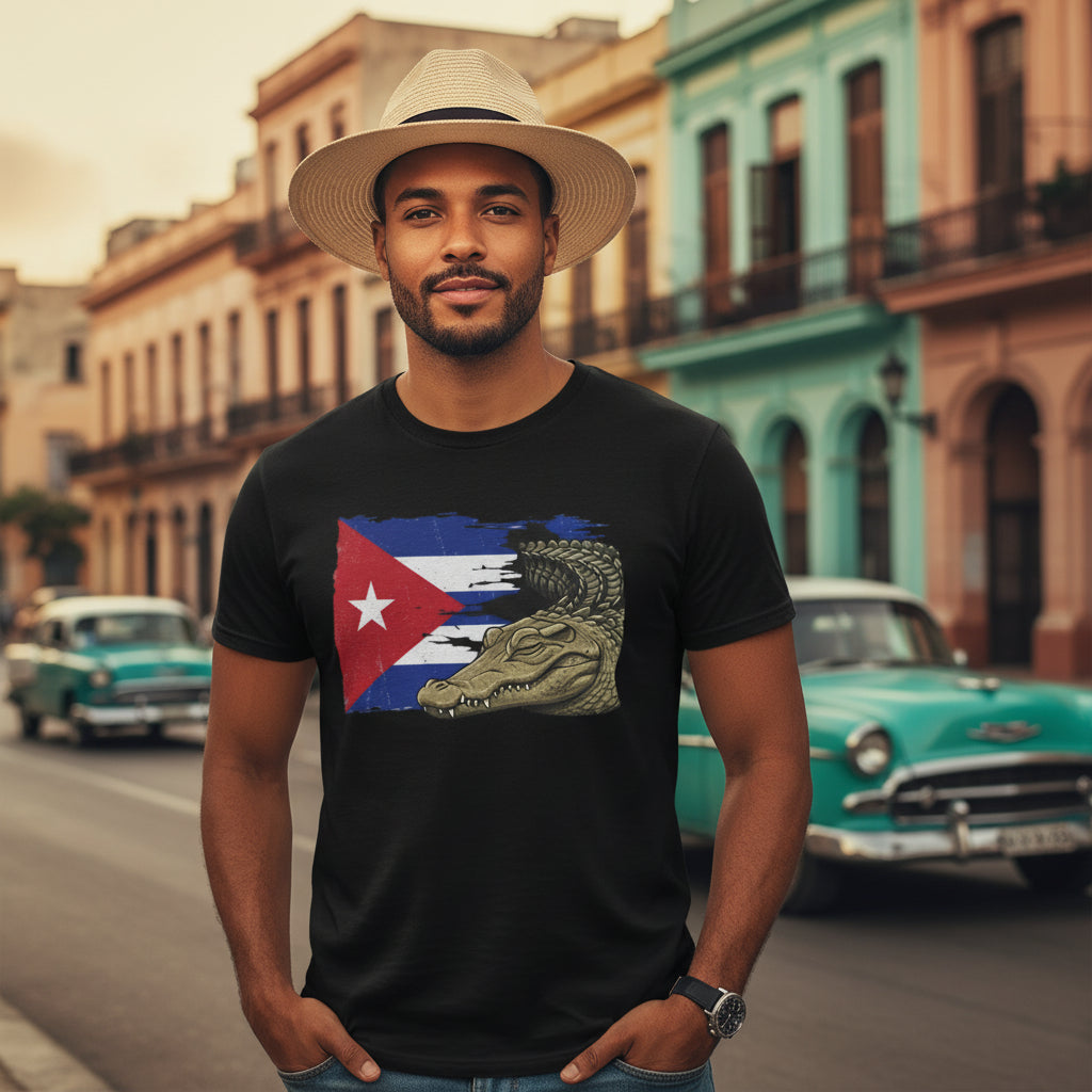 Man wearing a black t-shirt with a flag design and alligator graphic, standing on a street with vintage cars and colorful buildings.