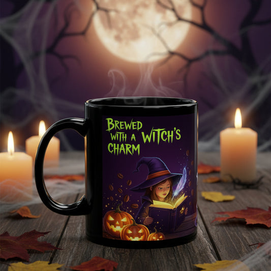 A black ceramic mug with a Halloween-themed illustration and the text 'Brewed with a Witch's Charm' in green, shown on a plain white background.