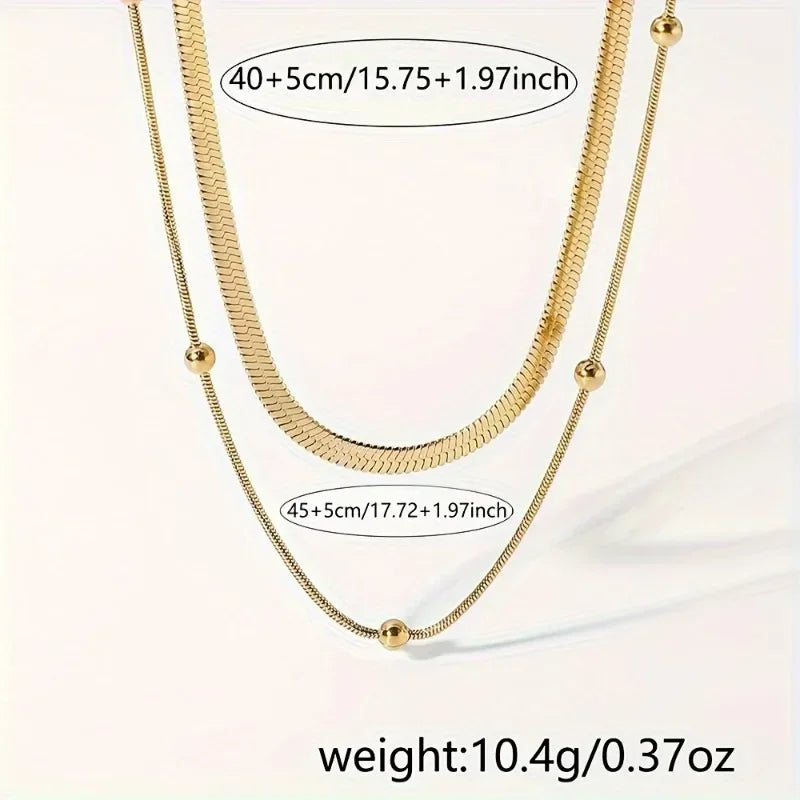 Gold necklaces with measurements and weight on a light background
