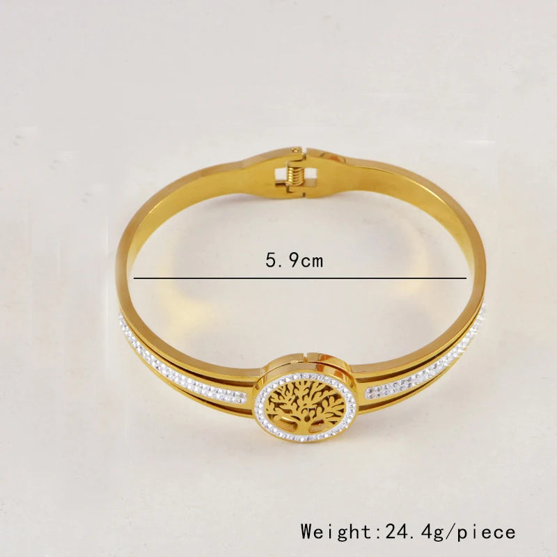 Gold bracelet with tree of life design and measurement details on a light beige background
