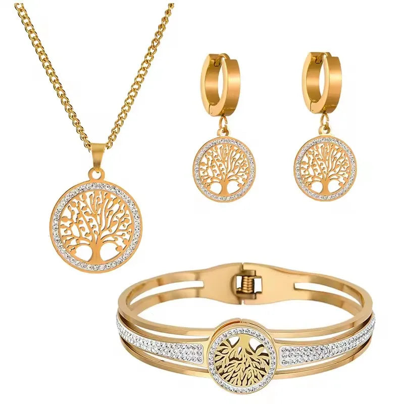 Gold jewelry set with necklace, earrings, and bracelet on a white background