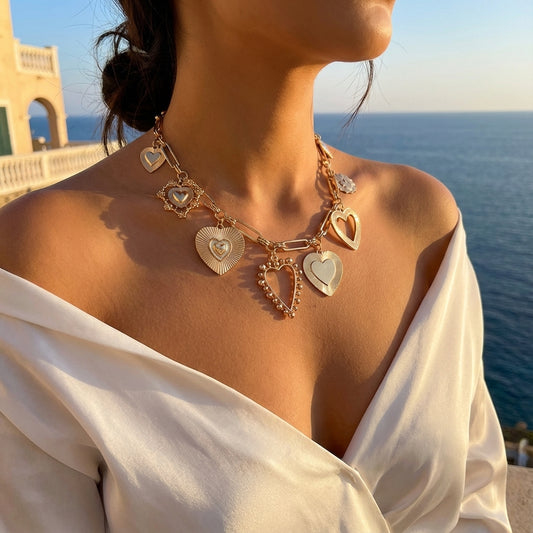 Woman wearing a gold heart-shaped necklace with a scenic ocean view in the background